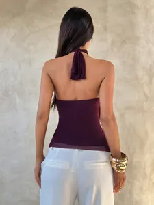 Back view of a purple halter neck sleeveless top featuring a delicate sheer mesh hem