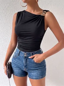 Close-up detail of black one-shoulder bodysuit with decorative gold buckle strap