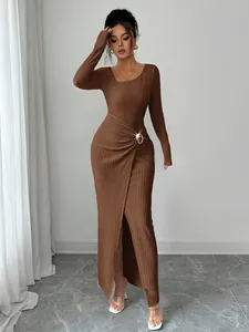Elegant textured knit maxi dress featuring an asymmetrical neckline and front slit.