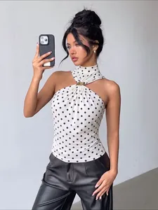 Elegant white and black polka dot halter neck top with gold metallic ring detail