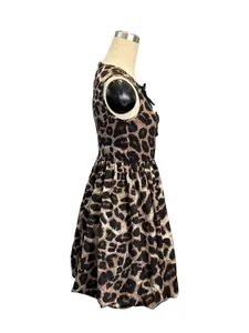 Side view of women's sleeveless leopard print dress with 3D floral accent on dress form.