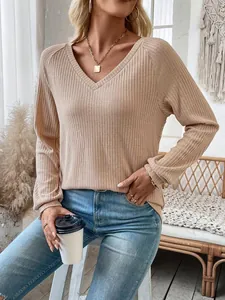 Stylish women's ribbed V-neck long sleeve top in apricot color featuring raglan sleeves
