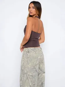 Women's sexy halter backless crop top in chocolate brown paired with camo pants