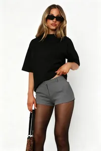 Detail of model outfit featuring black t-shirt and grey high-waisted shorts styling