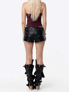Rear view of a tight maroon halter neck tank top paired with edgy black leather shorts.