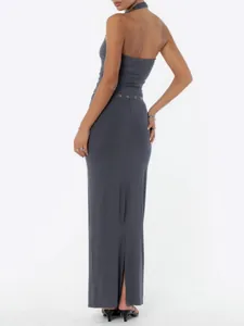 Back view of grey halter neck top and matching maxi skirt with silver eyelet details