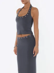 Close-up of slim fit halter neck crop top with metal eyelet details in charcoal gray.