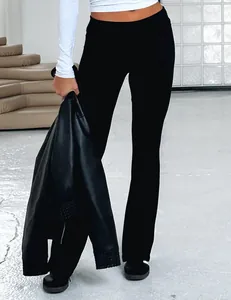 Detail view of black low-waist flared pants with a slim fit and stylish design.