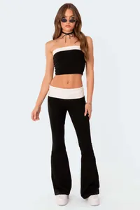 Stylish two-piece set featuring black tube top and low-rise flare pants with white trim.