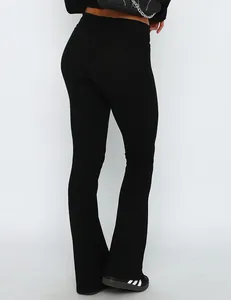 Detailed back view of slim fit black flare pants featuring stylish low waist fold-over design