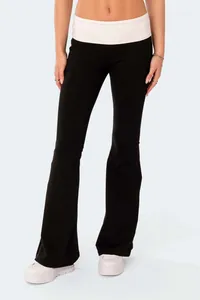 Slim fit black low-waist flare yoga pants with a contrasting white waistband on model