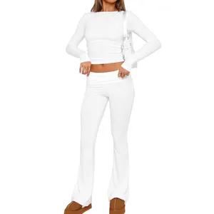 Detailed view of women's white slim-fit long-sleeve crop top and flared pants set