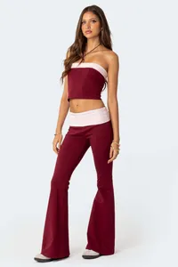 Stylish two-piece maroon and pink set with strapless crop top and low-rise flare pants