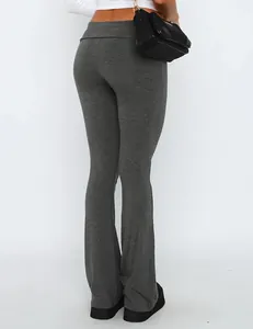 Detailed view of grey low-rise flared leggings featuring a stylish fold-over waistband design