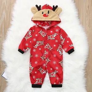 Detail view of a festive red Christmas baby romper with reindeer and snowflake prints.