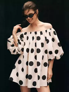 Fashionable off-shoulder puff sleeve mini dress with large black polka dot print design