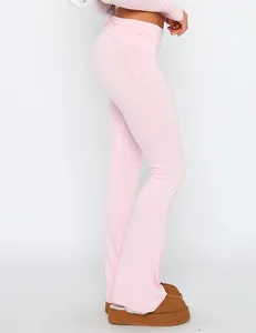 Side view of pink slim-fit flared pants showing the low-waist folded waistband design