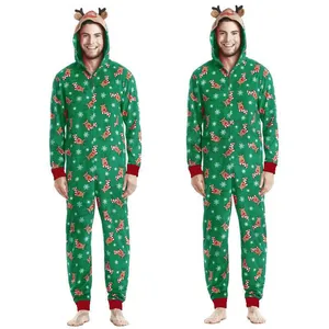 Full body view of a man wearing a green Christmas hooded onesie with reindeer print