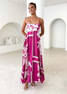 Full-length view of a floral maxi dress worn by a model in a bright minimalist interior