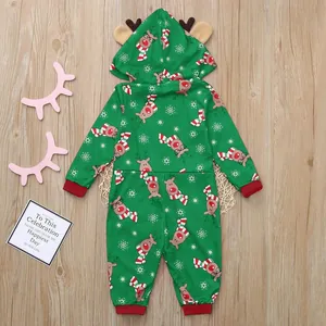 Detailed view of green Christmas hooded romper with festive reindeer and snowflake print