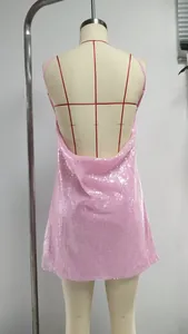 Back view of a pink sequined backless mini dress showing detail of halter strap design