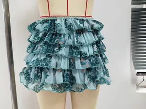 Close-up detail of the intricate floral printed tiered ruffles on this stylish blue mini skirt