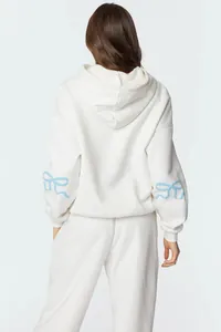 Detailed back view of white hoodie featuring light blue bow sleeve designs