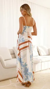 Back view of elegant floral and striped print maxi dress with spaghetti straps