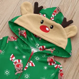 Close-up detail of green Christmas jumpsuit featuring 3D reindeer hood and festive prints
