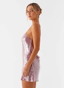Side view of pink sequined backless mini dress showing shiny texture and slim fit