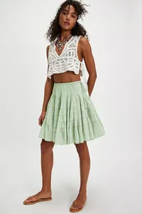 High waist light green tiered lace cake skirt for women styled with a white crochet top
