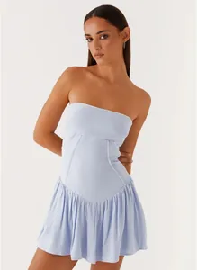 Detail view of light blue strapless backless mini dress with pleated hem and corset seams