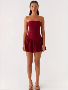 Full front view of an elegant wine red strapless pleated mini dress worn by a model