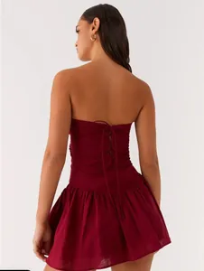 Detailed back view of a burgundy strapless mini dress with elegant lace-up corset design