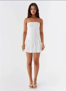 Front view of a chic white strapless backless pleated mini dress for women