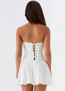 Detailed back view of a elegant white strapless dress featuring a lace-up corset tie design