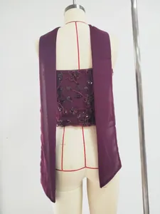 Detail of burgundy sequin floral strapless dress with matching long scarf drape.