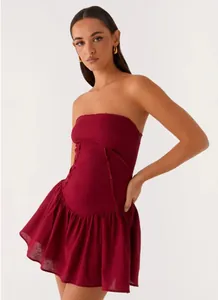 Elegant burgundy strapless mini dress with raw hem details and slim waist fit