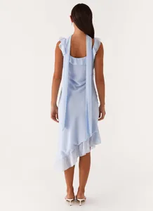 Elegant back view of a light blue ruffle asymmetrical dress with chic backless design.