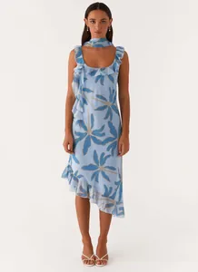 Full body view of elegant blue floral dress featuring ruffled trim and asymmetric hem
