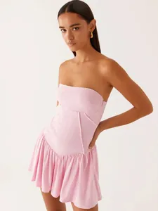 Elegant pink strapless tube mini dress with a pleated ruffle skirt for summer fashion