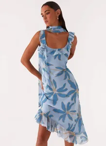 Detail of blue floral ruffle dress with asymmetrical hem and matching neck scarf