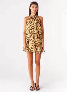 Detailed view of women's halter sleeveless mini dress featuring a bold tiger print.