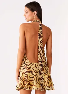 Close-up back view of a sexy tiger print halter neck backless mini dress with straps