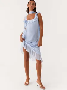 Light blue sleeveless ruffle dress with asymmetrical hem and matching neck scarf