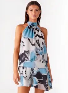 Detailed view of women's halter sleeveless mini dress with blue abstract print.