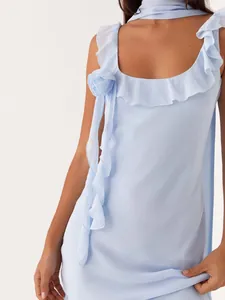 Elegant light blue summer dress featuring ruffle edges and a decorative shoulder rose.