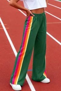 Detail view of women's green wide-leg lounge pants with colorful rainbow side stripes