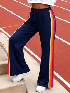 Detail view of navy blue wide-leg track pants featuring vibrant multi-color side stripes.