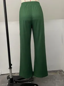 Detailed back view of fashionable green wide-leg trousers for women with elastic waist